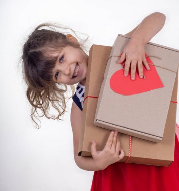 Hediye ile çocuk. Hediye kutusu beyaz izole tutan küçük gülümseyen kız. 