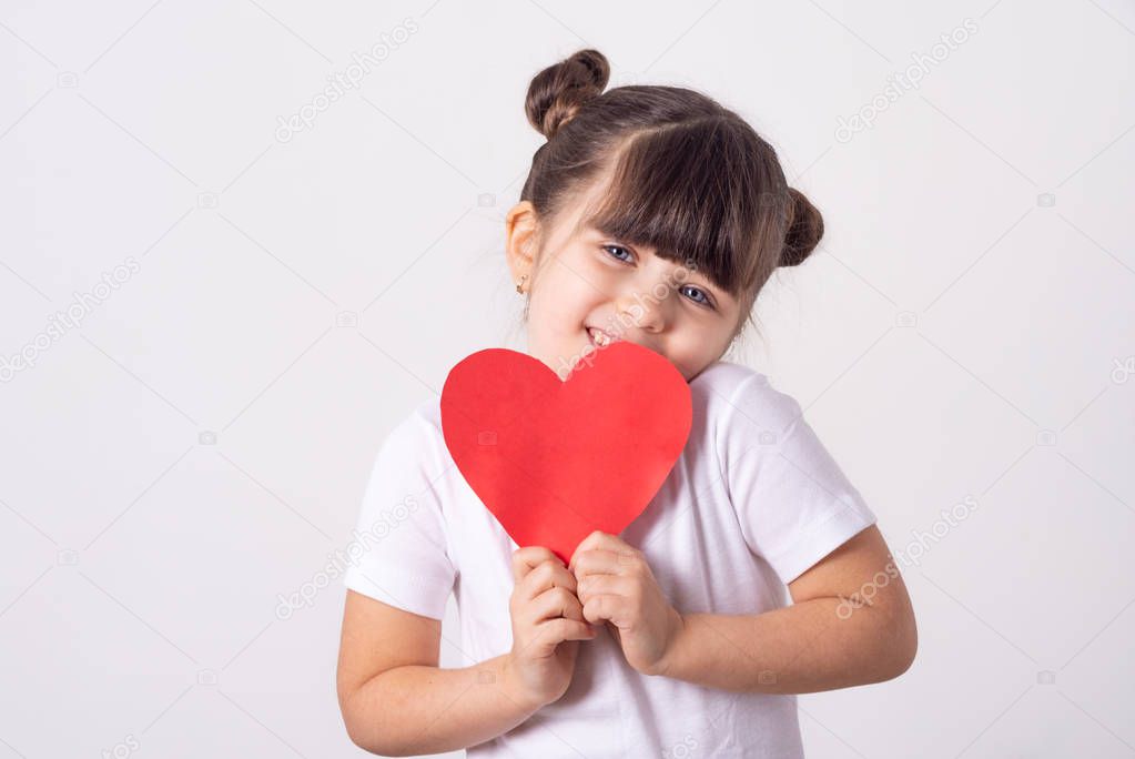 Happy mothers day, mom! Smiling little kid congratulate mother and giving paper heart. Isolated, free space for advertising