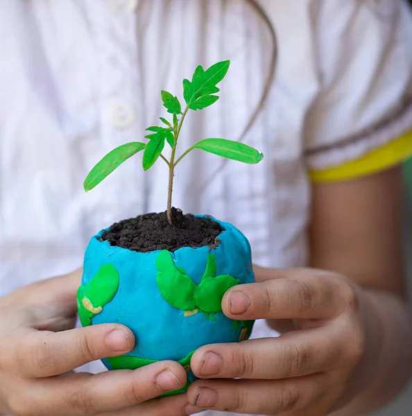 Globe on hand with plant, safe the world , ecology concept