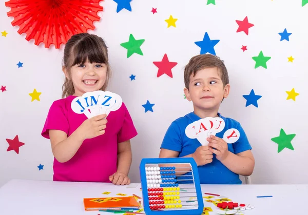 Children learning english letters. Boy and girl study english language.