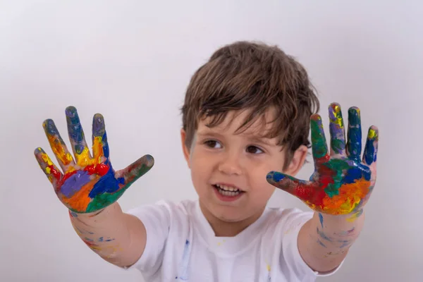 Kid, 3 years old is painting in kindergarten or pre-primary or nursery school. Washable finger paints for babies kids.