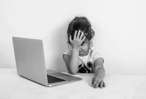 Shocking content. Preschool girl surfing internet with shocked face. Girl stunned expression and touch her head. Unbelievable news. Surfing internet laptop. Parental advisory concept. Black and white