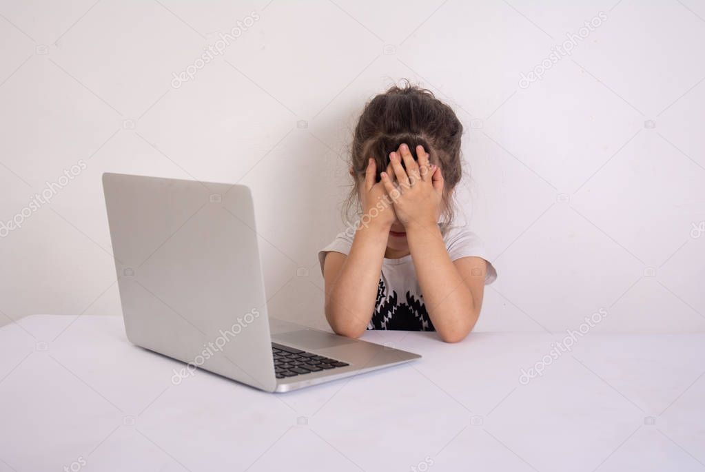 Little girl reacts with shock after accidentally watching inappropriate content while surfing the internet. Internet safety.