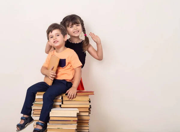 Happy kids with books is staying on white background. Ready for school. Back to school.