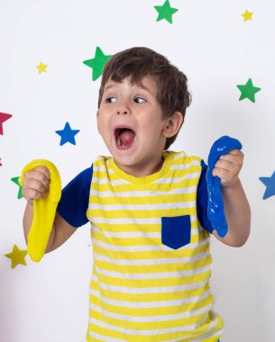 Slime ile sevimli komik çocuk oynamak. Çocuk sıkmak ve streç oyuncak Slime.