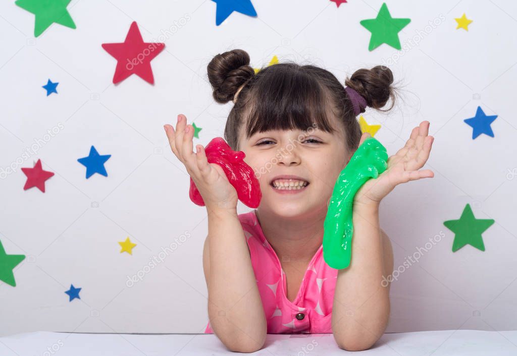 Kid play with handgum. Slime in children hands.  
