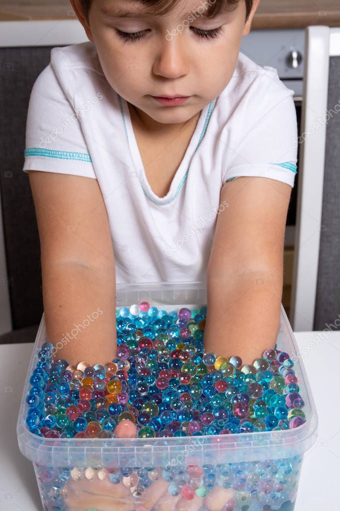 Child playing orbeez. Orbeez balls - sensory water beads.