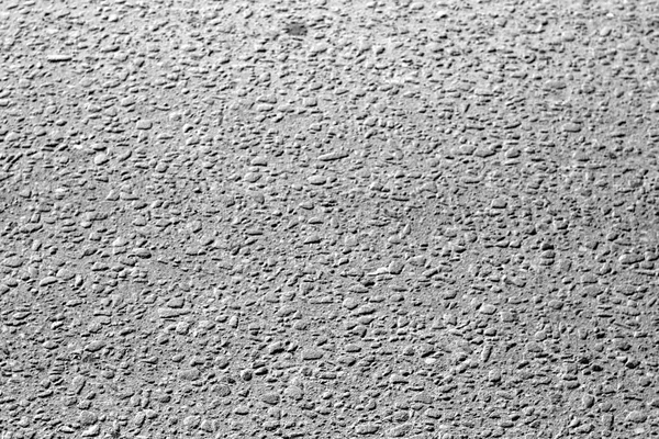 Dirty asphalt road texture with blur effect in black and white. Abstract background and texture for design.