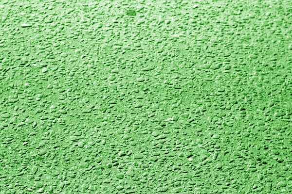 Dirty asphalt road texture with blur effect in green tone. Abstract background and texture for design.