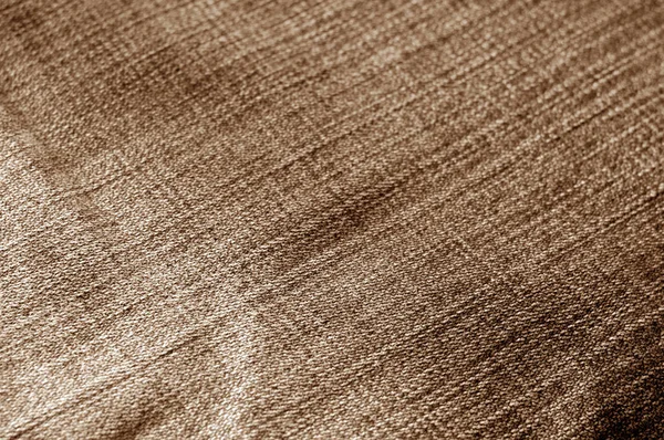 Jeans cloth pattern with blur effect in brown tone. Abstract background and texture for design.