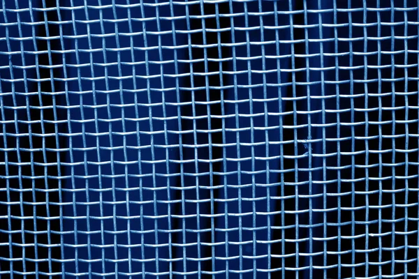 Metal mesh grid pattern in navy blue tone. Abstract background and texture.