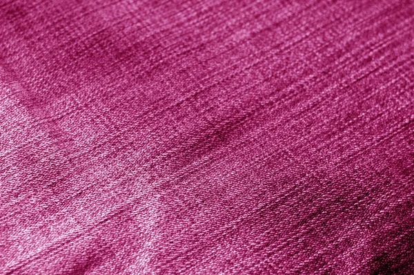 Jeans cloth pattern with blur effect in pink tone. Abstract background and texture for design.