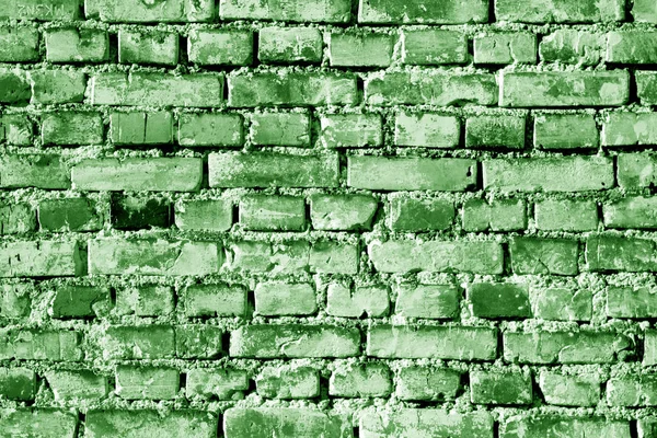 Grungy weahered brick wall in green tone. Abstract background and texture for design.