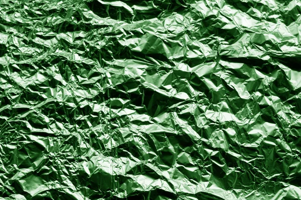 Metal foil texture in green color. Abstract background and texture for design.