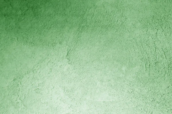Grungy cement wall in green color. Abstract background and pattern for design.