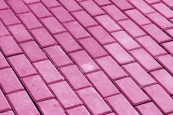 Cobble stone pavement in pink tone. Abstract background and texture for design.