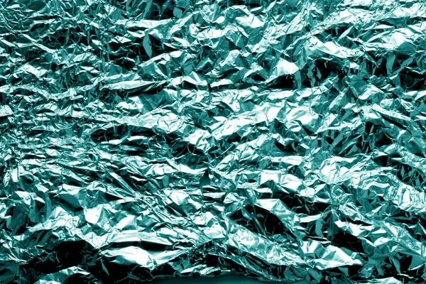Metal foil texture in cyan tone. Abstract background and texture for design.
