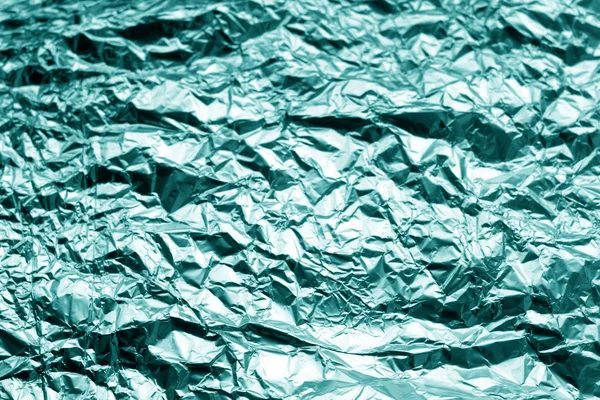 Metal foil texture in cyan tone. Abstract background and texture for design.