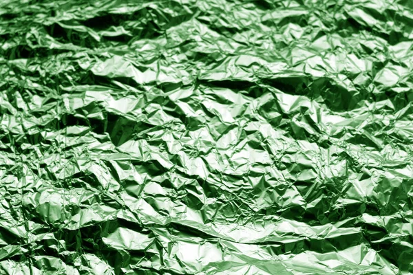 Metal foil texture in green tone. Abstract background and texture for design.