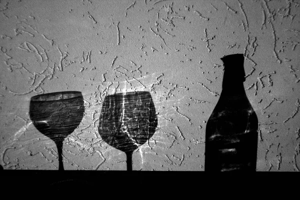 wine bottle and two glasses shadow wine bottle and two glasses shadow in black and white. Abstract backround and view