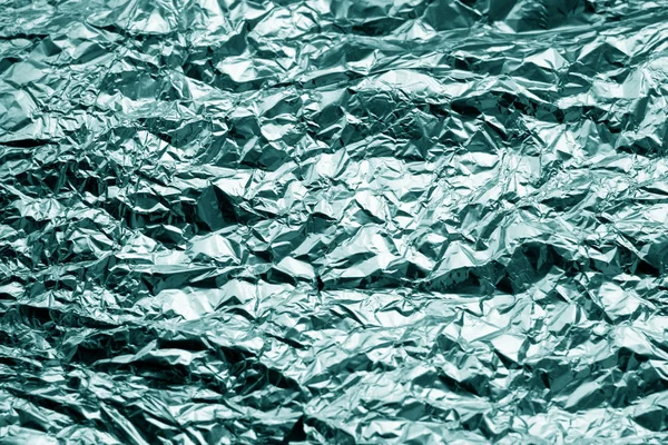 Metal foil texture in cyan tone. Abstract background and texture for design.