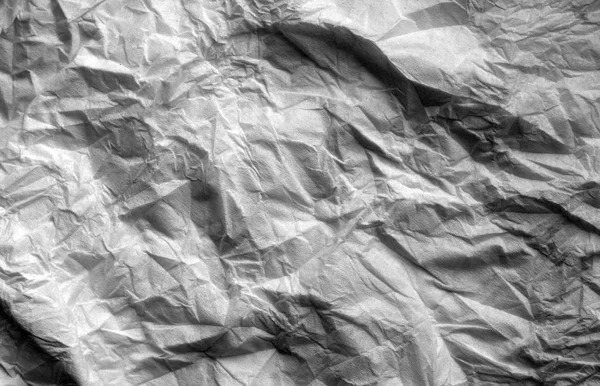 Crumpled sheet of paper in black and white. Abstract background and texture for design.
