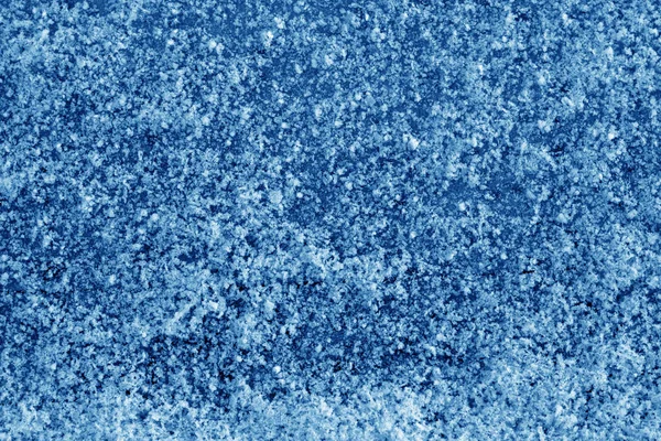 Frost on car glass texture in navy blue tone. Abstract background and texture for design.