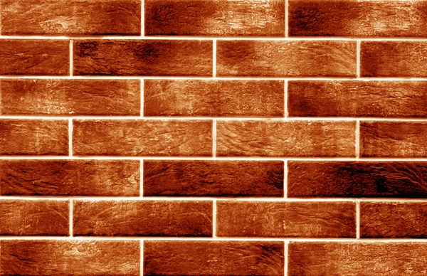 Decorative brick wall in orange color. Abstract background and texture for design.