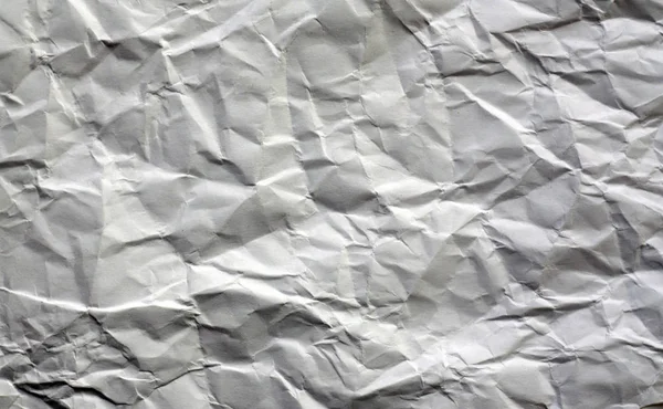 White color crumpled sheet of paper. Abstract background and texture for design.