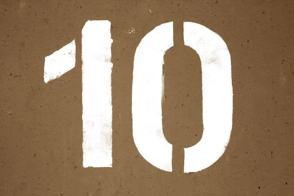 Nummer 10 i stencil på metall vägg i brun ton. — Stockfoto
