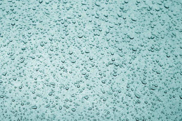 Water drops on car surface in cyan tone. — Stock Photo, Image