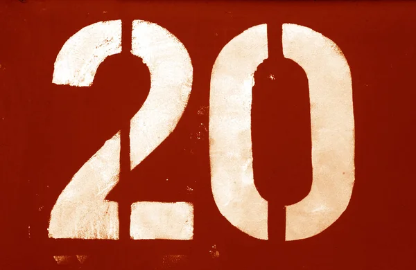 Number 20 in stencil on metal wall in orange tone. — Stock Photo, Image