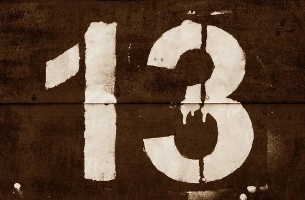 Number 13 in stencil on metal wall in brown tone. — Stock Photo, Image