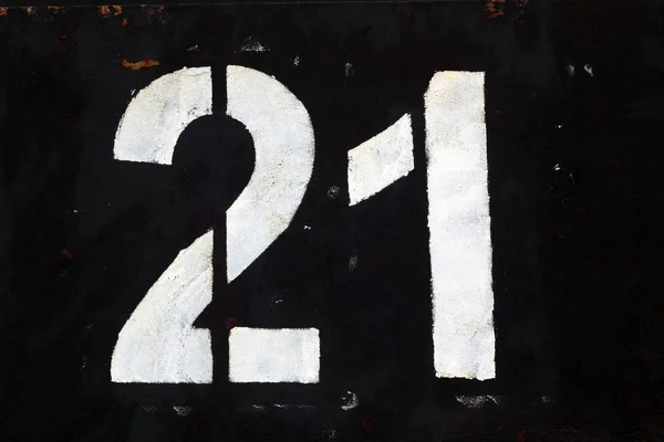 Number 21 in stencil on black metal wall. — Stock Photo, Image