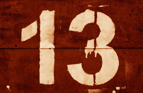 Number 13 in stencil on metal wall in orange tone. — Stock Photo, Image