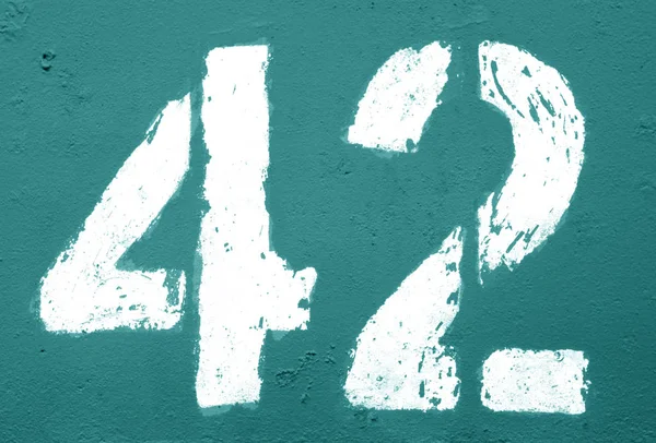 Number 42 in stencil on rusty metal wall in cyan tone. — Stock Photo, Image