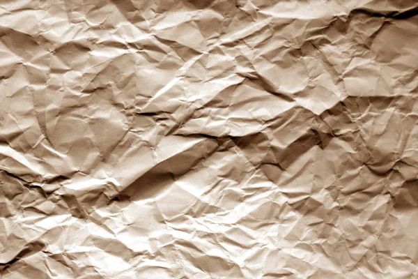Crumpled sheet of paper in brown color.