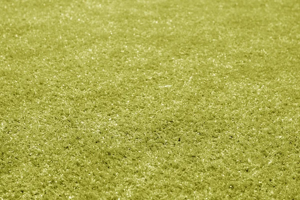 Empréstimo de campo de futebol de grama artificial com efeito de borrão em amarelo — Fotografia de Stock