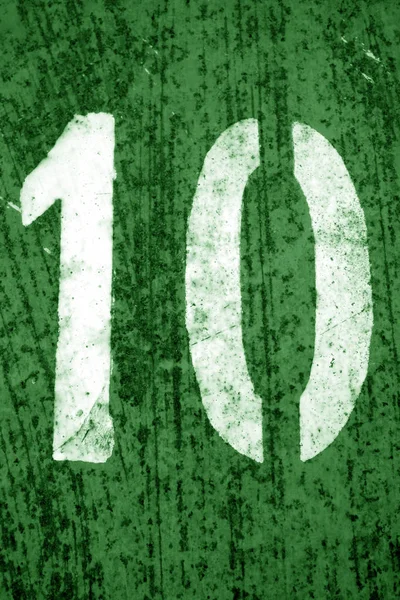 Numero 10 in stencil su parete metallica in tono verde . — Foto Stock