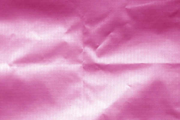 粉红色透明塑料表面的皱褶. — 图库照片