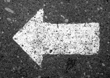 Siyah beyaz asfalt üzerinde sol işaret oku.