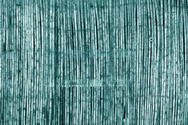 Cyan tonlu yıpranmış bambu çit.