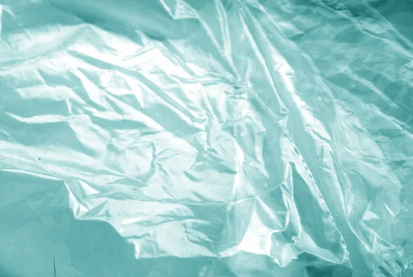 Textura de plástico transparente envoltura vieja en tono cian . — Foto de Stock