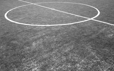 Siyah ve beyaz suni otlu bir futbol sahası parçası.