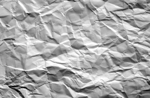 Crumpled sheet of paper with blur effect in black and white.