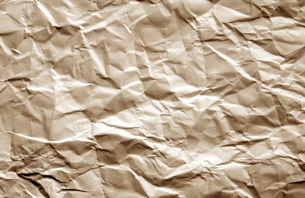 Crumpled sheet of paper with blur effect in brown color. — Stock Photo, Image