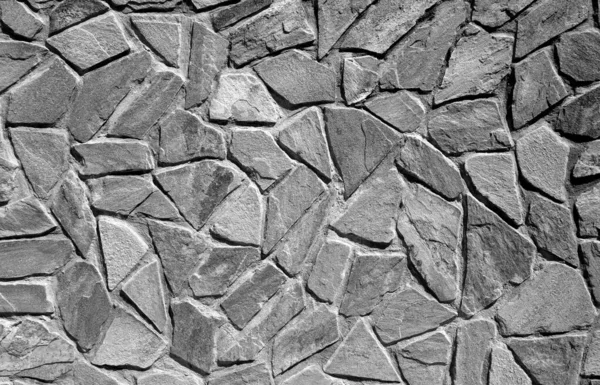Muro di pietre antiche in bianco e nero . — Foto Stock