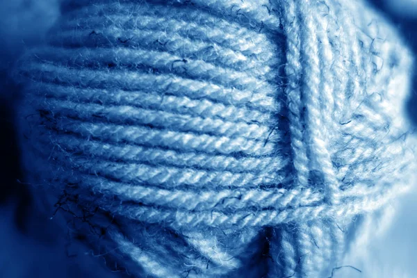 Yarn ball close-up with blur effect in navy blue tone. — Stock Photo, Image