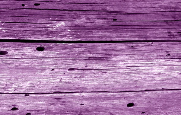 Old grunge wooden fence pattern in purple color. — Stockfoto