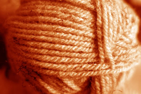 Yarn ball close-up with blur effect in orange tone. — Stock Photo, Image